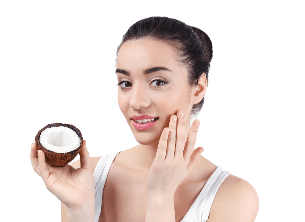 Close-up image of coconut oil being applied to the skin, highlighting its moisturizing and soothing benefits for dry and irritated skin.